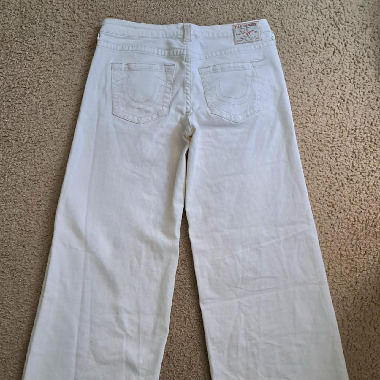 white True Religion denim high waisted wide leg jeans with distressed hem
