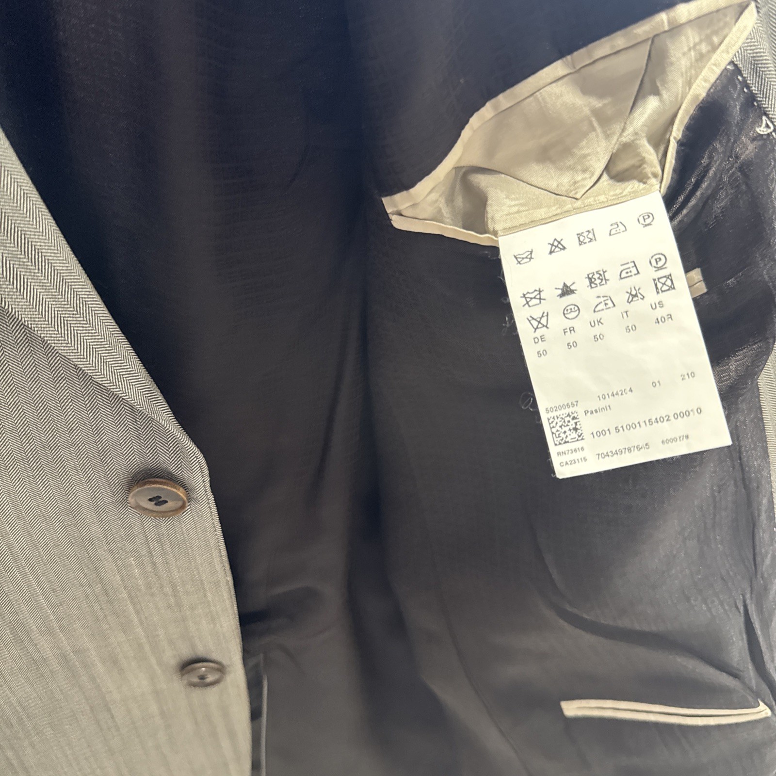 Set of four HUGO BOSS suits/blazers in various sizes/shades of blue and gray.