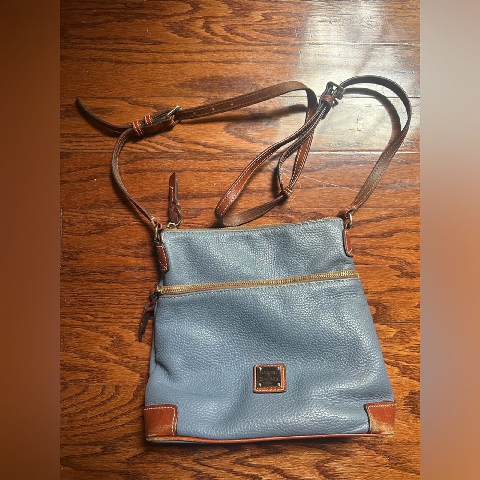 Dooney & Bourke crossbody bag leather in a shade of blue and brown leather trim