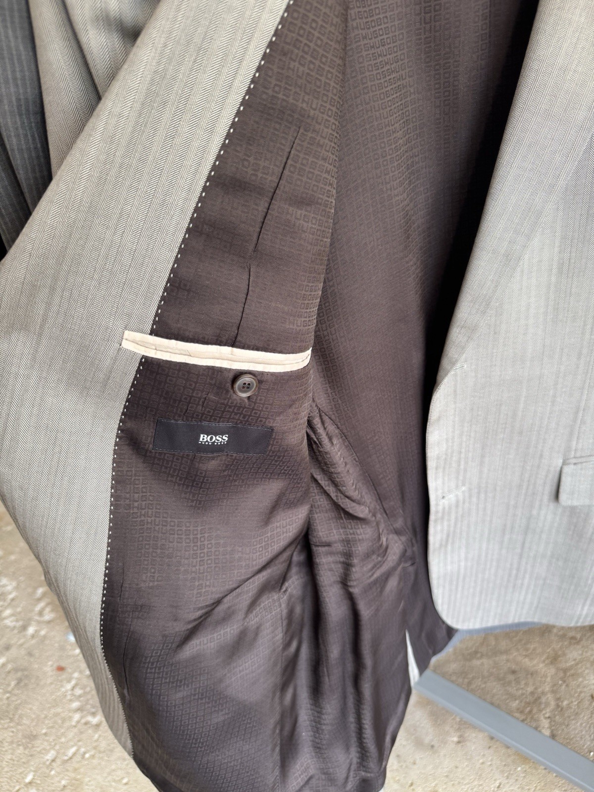 Set of four HUGO BOSS suits/blazers in various sizes/shades of blue and gray.