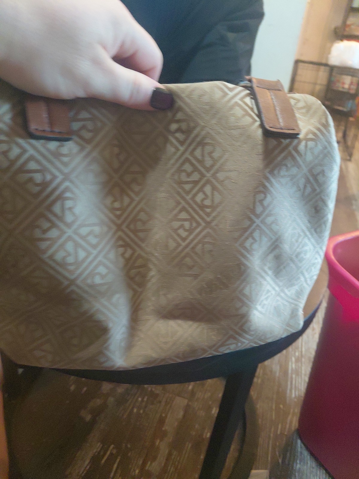 Beige and brown Relic Caraway tote bag With a logo pattern and brown handles.