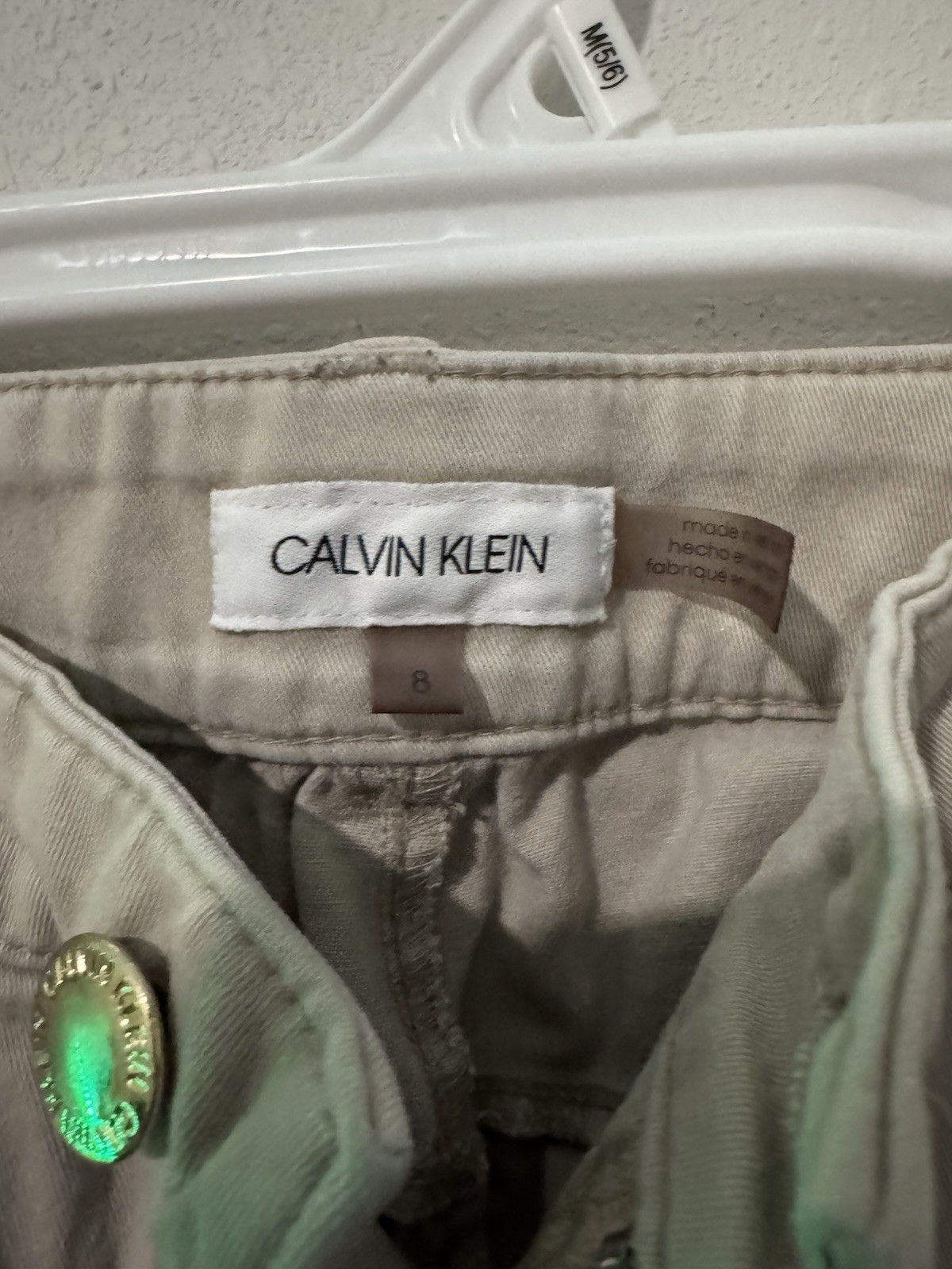 cotton twill chinos, featuring a zipper fly and button closure