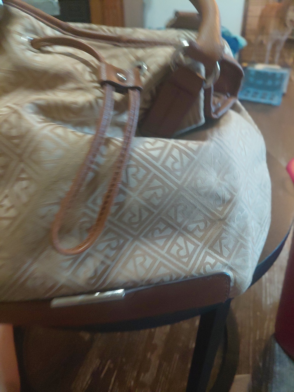 Beige and brown Relic Caraway tote bag With a logo pattern and brown handles.