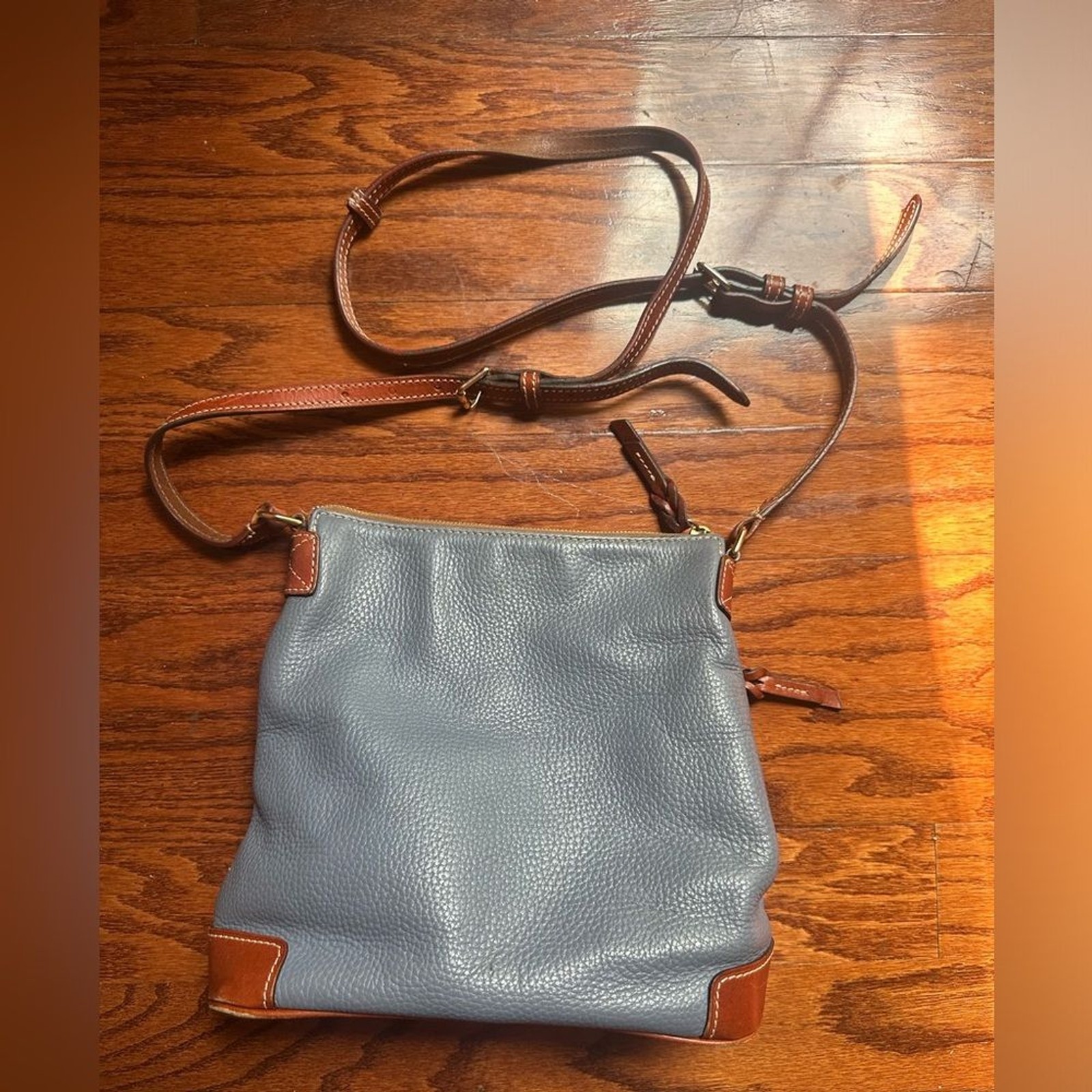 Dooney & Bourke crossbody bag leather in a shade of blue and brown leather trim