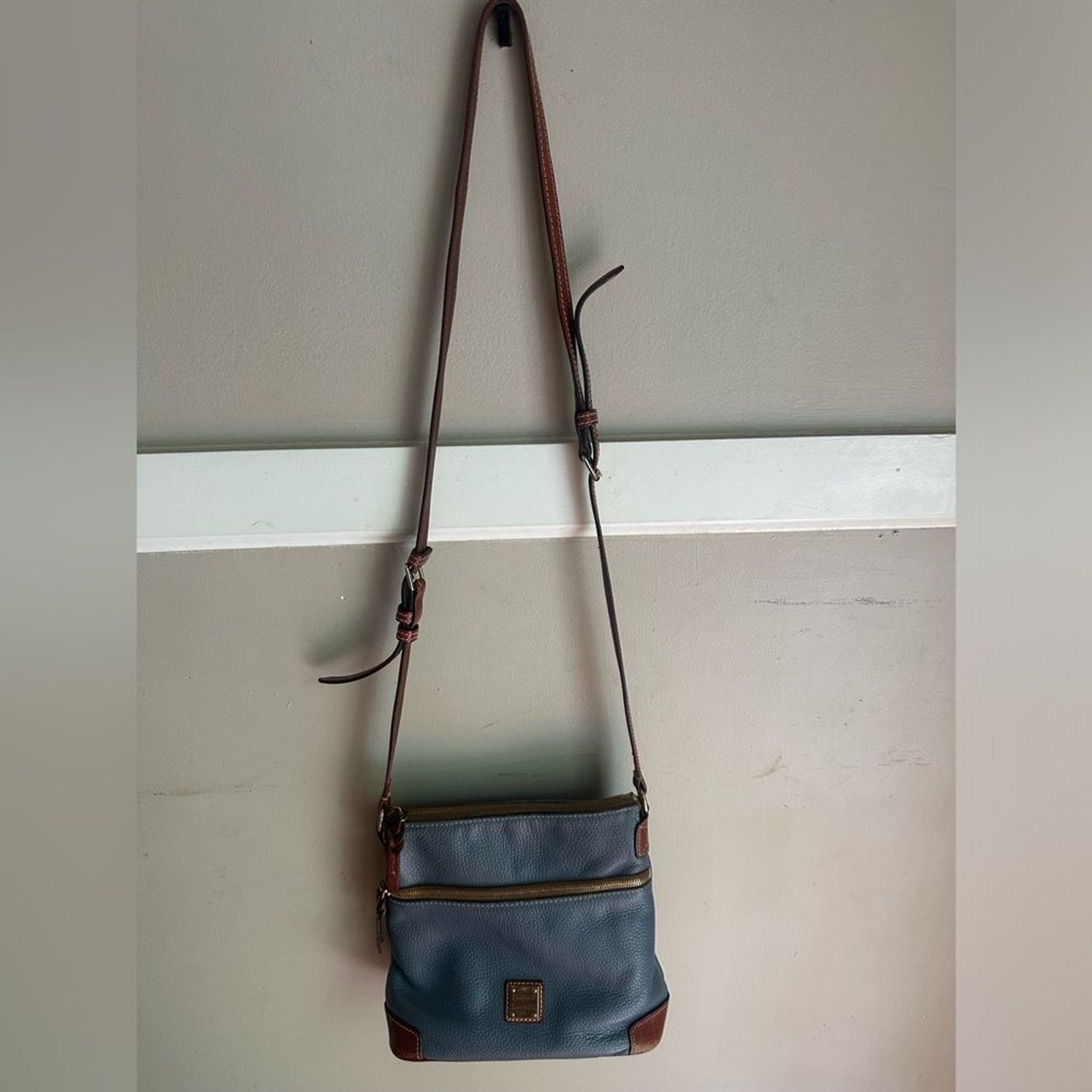 Dooney & Bourke crossbody bag leather in a shade of blue and brown leather trim