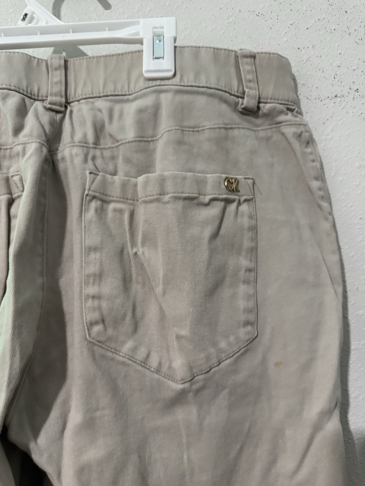 cotton twill chinos, featuring a zipper fly and button closure