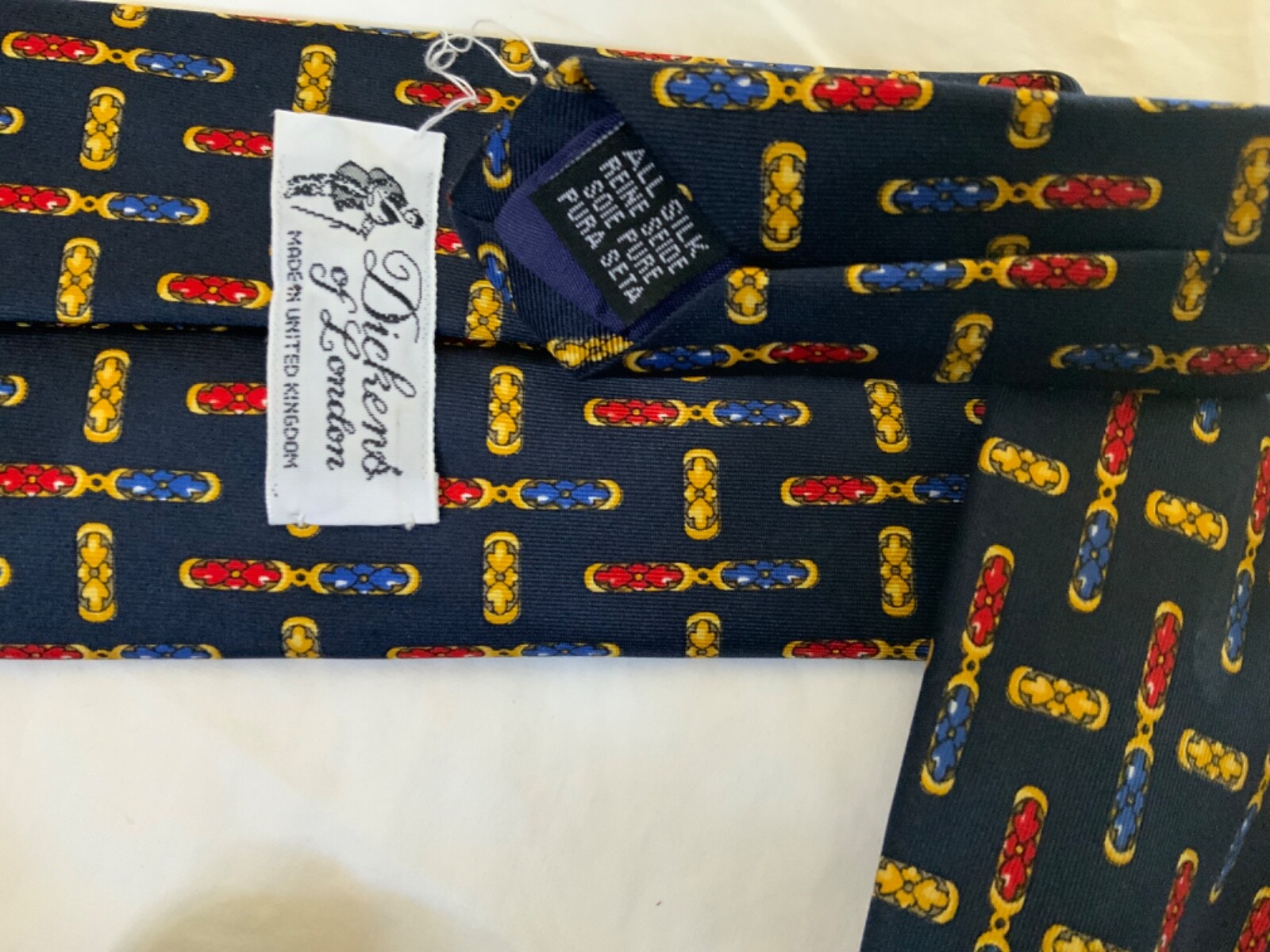 Dickens of London tie United Kingdom navy blue red yellow arrow link pattern